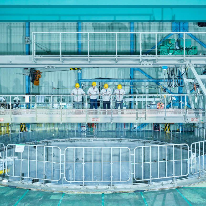 people in hard hats in industrial setting people in hard hats in industrial setting