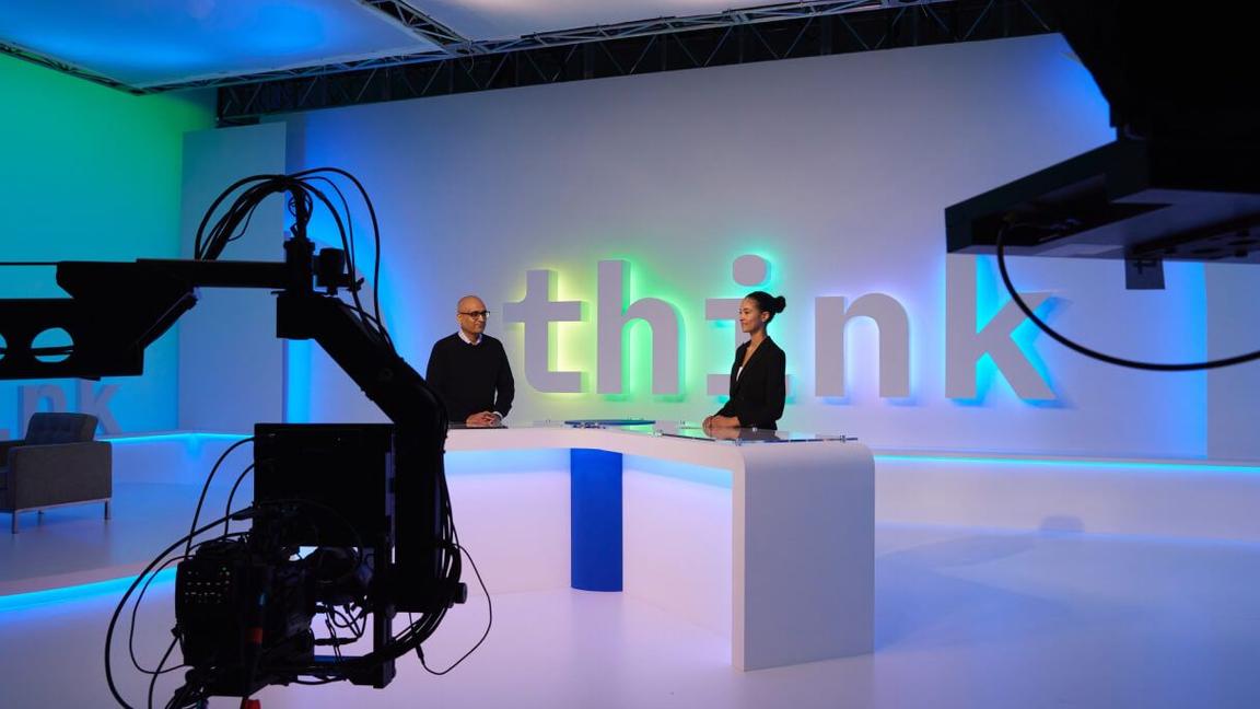 Think studio set with host conducting SME interview Think studio set with host conducting SME interview